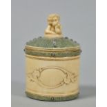 A late 19/20th century tea caddy encased in ivory and shagreen with cherub finial and cut steel