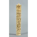 A 19c Chinese ivory bodkin tube profusely carved in relief with figures and village scenes, the