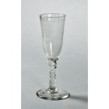 A late 18/early 19c short ale glass with a drawn trumpet bowl, facet cut stem on a circular domed