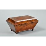 An 18c yew wood needlework box of sarcophagus form, the hinged cover with inlaid burrwood panel,