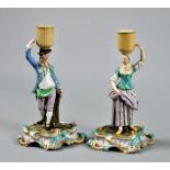 A pair of Meissen candlestick figures in the form of harvesters, each on a rococo scrolling base,