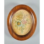 A Victorian oval silkwork picture of a bouquet of flowers, oval framed and glazed, 6.5" x 5".