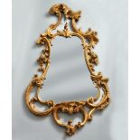 A George III rococo giltwood mirror of cartouche form attributed to Thomas Johnson, 42" x 23".