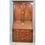 A mid Georgian mahogany bureau bookcase , the upper shelved bookcase with a short stepped cornice