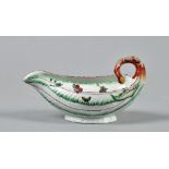 A Worcester leaf moulded sauce boat, painted with flowers and insects and having curled twig handle,