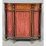 An early 19c mahogany credenza of small proportion with breakfront, having a shelved interior over