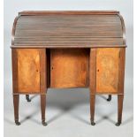 An early 19c mahogany tambour top desk fitted six pigeon holes over four short drawers, with leather