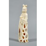 A Japanese carved ivory figure of a lady with fan in right hand and holding a lotus flower in her