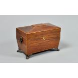 A late Regency rosewood two compartment tea caddy of sarcophagus form with slight facet domed hinged