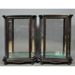 A pair of mid 19c ebonised brass rail inlaid display cabinets with a niello floral panel to the