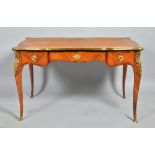 A 19c Louis XV style kingwood serpentine centre table crossbanded and line inlaid with an outer