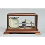 A late 19c barograph in glazed mahogany case, the movement having an eight fold vacuum chamber and