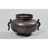 A 19c Chinese bronze bowl of squat baluster form with serpent side handles and with Chinese key