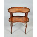 A late 19c two tier marquetry tea table of kidney shaped form with raised chequer galleries, the