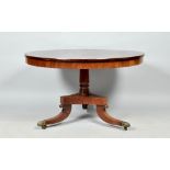 An early 19c mahogany circular tilt top pedestal breakfast table with shallow frieze and supported