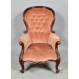 A mid Victorian mahogany show framed and upholstered button back cameo armchair, carved and on