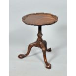 A George III mahogany Chippendale style lamp/kettle stand, the circular top with a carved raised