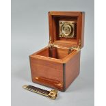 A Dunhill figured mahogany humidor of cube form and with ebony edging, with hinged cover, fitted