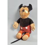 A soft toy Mickey Mouse circa 1930, he with upturned nose and having had oval bakelite eyes but