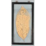 An early 20c leaf silhouette of King George V in ceremonial uniform, framed and glazed, 11" x 5".