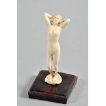 A 1930/40 ivory figure of a naked maiden standing on a rock, on a bakelite base, the figure 4.75"