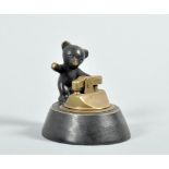 A Walter Bosse style patinated bronze table lighter, the stem mounted by a bear cub, 2.5"h, 2.75"w.