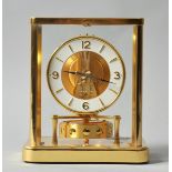 A mid 20c Swiss Jaeger-Le-Coultre Atmos clock in a glazed brass case, the movement standing on a