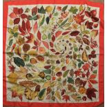 A Hermes of Paris ladies silk printed headscarf, decorated with coloured leaves on an ivory