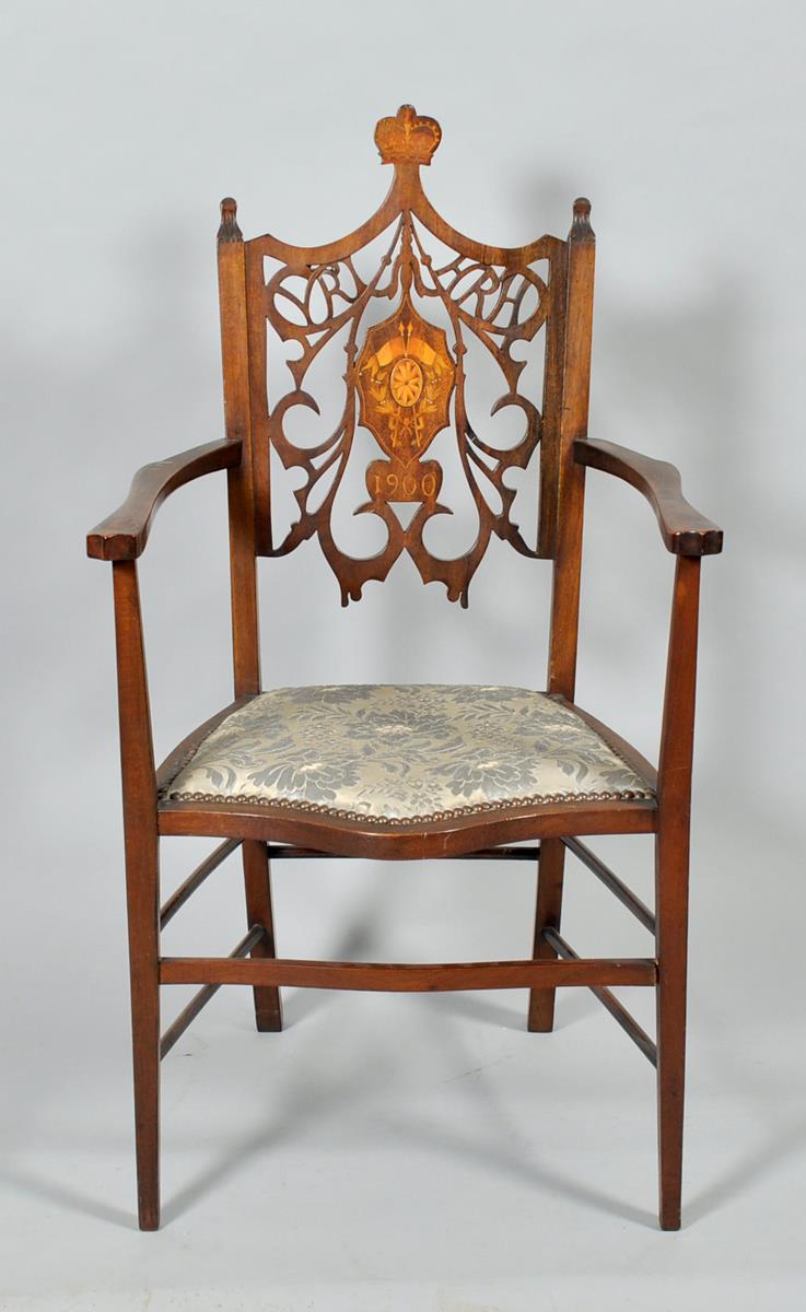 A late 19c mahogany and beech open armchair , with a shaped and studded upholstered seat, the carved