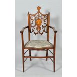 A late 19c mahogany and beech open armchair , with a shaped and studded upholstered seat, the carved