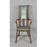 A late 19c/early 20c Arts & Craft spindle back bow armchair with shaped seat and supported on