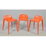 Three Italian Jasper Morrison designed orange stacking stools.