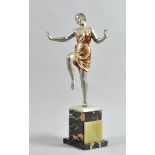 A silvered Art Deco figure of a dancing girl in a gold painted dress, after Ignacio Gallo, on a