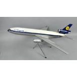 A Skyland model aeroplane, being a Lufthansa McDonnell Douglas DC30-10 with chromed stand, 29"l,