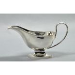 A Georgian style sauce boat , with scrolling handle and oval base, London 1916, 7"w.