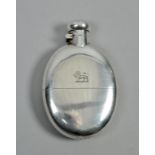 A late Victorian pocket flask with pull off tot, with hinged screw top and incised lion motif,