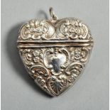A Continental silver heart shaped pendant vesta box, embossed with cartouche and flowers, 1.75"w.