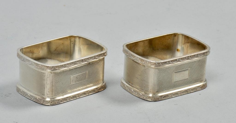 A pair of rectangular napkin rings, engine turned and with cast borders, Birmingham 1939, each 2"