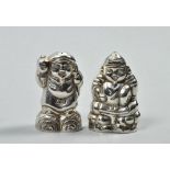A pair of Oriental silver novelty pepper and salt pots in the form of Oriental gentlemen, each 2"h.