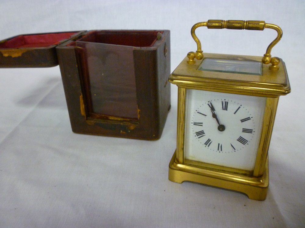 An old French carriage clock with rectangular enamelled dial in gilt brass glazed traditional case