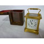 An old French carriage clock with rectangular enamelled dial in gilt brass glazed traditional case