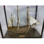 A wooden scale -built model of HMS Endeavour within glazed rectangular display case