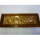 A Newlyn copper rectangular plaque decorated in relief with two fish and scrolls 5" x 19", framed