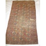 An old Eastern hand knotted wool rug with medallion decoration on red ground (af) 67" x 40"