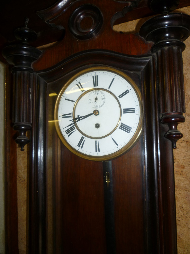 A good quality old Vienna regulator wall clock with enamelled and brass circular dial, single