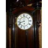 A good quality old Vienna regulator wall clock with enamelled and brass circular dial, single