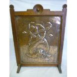 An oak and copper rectangular fire screen, believed Hayle copper, decorated in relief with a