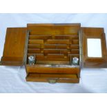 A late Victorian/Edwardian walnut stationery box with compartments enclosed by twin sloping covers