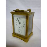 A French carriage clock with enamelled rectangular dial and subsidiary seconds dial in brass