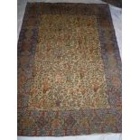 An old Eastern hand knotted wool rug with floral decoration within geometric borders 79" x 56"